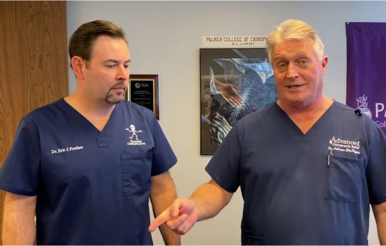 Prather-About Dr. Prather 4 Dr. Prather standing next to another doctor, both in navy scrubs.