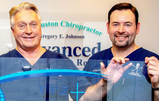 Prather-The Ring Dinger 3 Dr. Prather and another person in blue scrubs holding up a sheet of plexiglass.