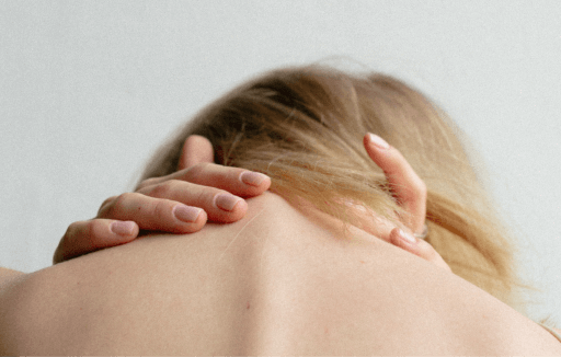 Prather-Spinal Fracture 2 Person leaning their head forward and holding their neck with both hands.
