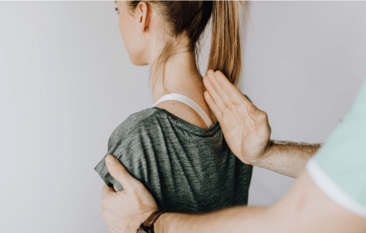 Prather-Herniated Discs 1 Chiropractor holding a hand on a patient's spine.