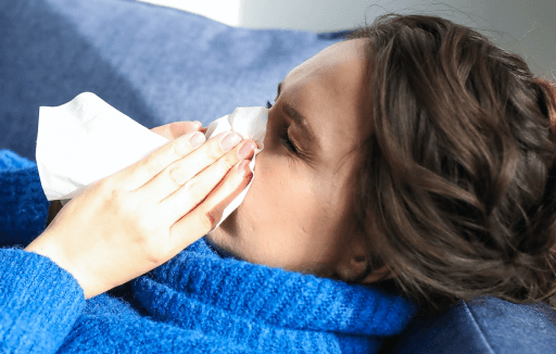 Prather-Allergies 1 Person lying down and blowing their nose.