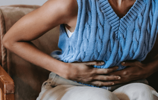 Prather-Heartburn & Digestive Health 1 Person sitting and holding their stomach.